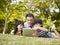 Asian father and children using tablet computer outdoors