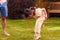 Asian Father And Daughter Having Fun Playing With Hula Hoop In Garden At Home