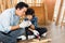 Asian father gives first aid to his son injured from woodwork