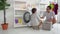 Asian Father is helping his son doing laundry in a washing machine in a domestic house work concept.