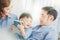 Asian father Mother and child are reading book wearing blue shirt posing for in bedroom in white room.To keep memories moment