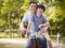 Asian father and son enjoying biking outdoors