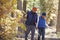 Asian father and son hiking in a forest, close up