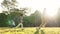 Asian father and son playing football outdoors in park