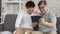 Asian father and son waving hands looking at camera, make video call with digital tablet