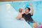 Asian Father take cute little Asian baby boy child to swimming class, Infant learn his first swim in pool with his dad