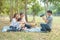 Asian father use digital camera take group photo of his wife,son and grandma in public park,Happy together of asia family have