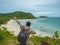 Asian fatty backpacker stand on view point on top of the island with idyllice beach ocean and blue sky in vacation time