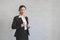 Asian female business smiling and wearing suit on wall background