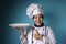 Asian Female Chef Shows Empty White Plate, Presenting Something, Copy Space