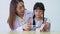 Asian female dentist teaching cute little girl brushing teeth with toothbrush and stomatologist telling girl child about oral
