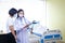 An Asian female doctor explains to his wife the treatment information of an African-American male patient.