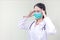 Asian female doctor Sitting in the examination room wearing a mask and pondering in  health care,pollution PM2.5,new normal and