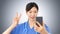 Asian female doctor takes a selfie gesturing the victory sign with her fingers