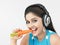 Asian female eating carrot