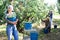 Asian female farmer carrying bucket with pears