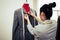 Asian female fashion designer girl making fit on the formal suit uniform clothes on mannequin model. Fashion designer stylish