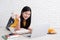 Asian female freelancer working on laptop computer at home.woman lying down on carpet at brick wall.working online lifestyle