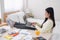 Asian female freelancer working on laptop computer on table at bedroom at home.working online lifestyle.work at home