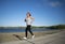 Asian Female Jogging Around Lake