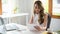 Asian female manager or businesswoman reviewing a financial report at her desk