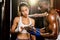 Asian female Muay Thai boxer and her personal boxing trainer. Impetus
