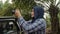 Asian female muslim photographer or videographer holding camera and shooting natural wildlife from open car, safari trip in the