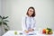 Asian Female nutritionist with fruits working at her desk. Health care and diet concept