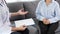 Asian female Patient listening intently to a male doctor explaining symptoms about health complaints in her home, health care