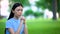 Asian female praying outdoors joining hands, religious belief, asking for help