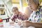 Asian female senior hold medicine pill,elderly woman consult her old people friend,help and read medicine labels drug prescription