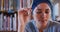 Asian female student wearing a blue hijab sitting and thinking with eyes closed