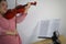 Asian female teacher teaching classical instrument violin online