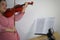 Asian female teacher teaching classical instrument violin online