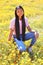 Asian female teenager in a field of wild African Daisy, Osteospermum, Mesa, Arizona, Maricopa County