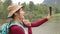 Asian female tourist blogger holding smartphone