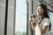 Asian female tourist traveling by train, taking snapshot photos by film camera