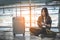 Asian female traveler using smart phone for checking flight time