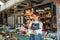 asian female vegetable seller standing with crossed arms