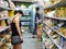 Asian female wears protective medical mask in asian grocery store amid coronavirus fears, germaphobe, health hygiene and pandemic