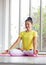 Asian female yoga teacher wearing a yellow shirt is training her body to be strong and healthy with yoga