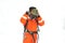 An Asian firefighters are wearing orange fire protection uniform mask on white background.