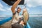 Asian fisherman smiles as he catches a grouper while fishing