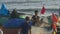 Asian Fishermen Check Net at Round Boats with Red Flags