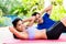 Asian fitness couple doing sit-up in tropical home