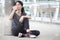 asian fitness woman taking a break after workout exercising drinking with a water bottle on street in urban city . Tired sport