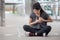 asian fitness young woman have chest pains or heart attack in workout exercising on street in urban city . Tired sport girl rest