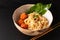 Asian Food concept homemade oriental egg noodles and spicy meatballs in ceramic bowl on black background