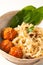 Asian Food concept homemade oriental egg noodles and spicy meatballs in ceramic bowl on white background
