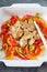 Asian food: fried chicken with tricolor bell peppers and chops